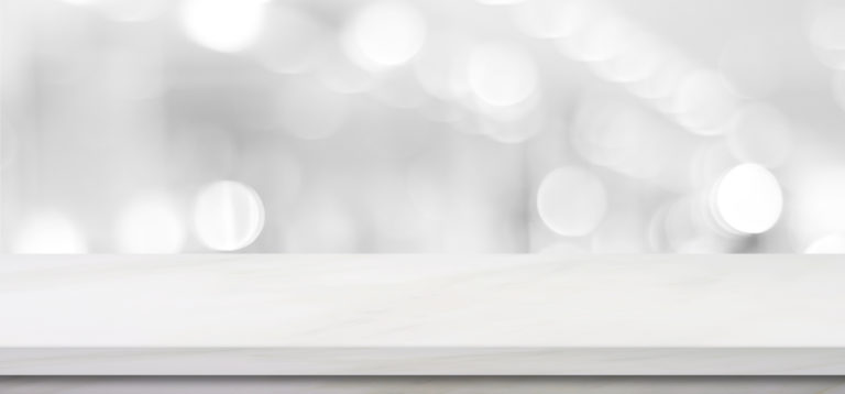 Empty white table top, counter, desk background over blur perspective bokeh light background, White marble stone table, shelf and blurred kitchen restaurant for food, product display mockup, template